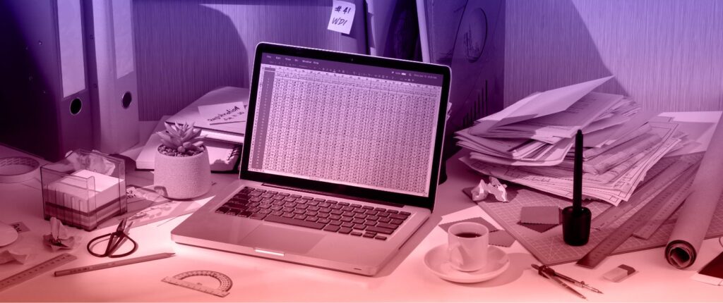 A laptop on a desk surrounded by papers and items, related to "The Cost of Bad Data in the Nonprofit Sector."